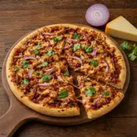 Smoky Gouda chicken pizza topped with barbecue chicken, red onion and fresh coriander
