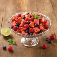 Mojito berry fruit salad with watermelon, strawberries, raspberries, blueberries, lime and fresh mint