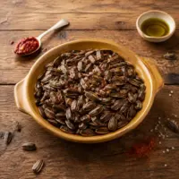 Roasted spicy sunflower seeds with chili garlic paste and olive oil on a rustic wooden table.