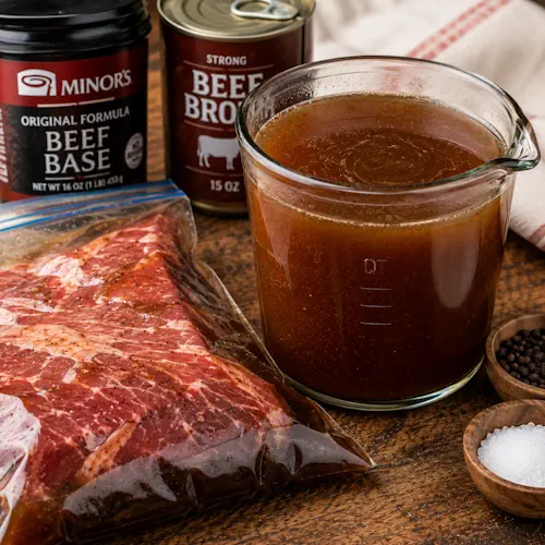 beef marinade and brisket marinade served on a rustic wooden table in a glass container