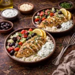 greek chicken bowls with lemon herb chicken, fresh vegetables, olives, and feta