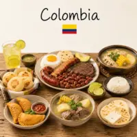Colombian Recipes with arepas bandeja paisa and traditional Colombian dishes on a rustic wooden table with a Colombian flag
