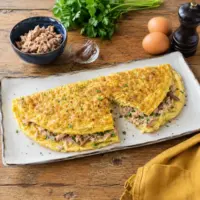 Air fryer tuna omelet made with eggs, canned tuna, anchovy fillets, fresh parsley, and black pepper