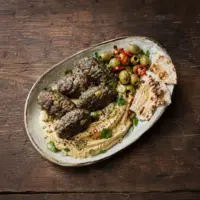 Beef koftas with green olives, hummus, flatbread, parsley and sumac.