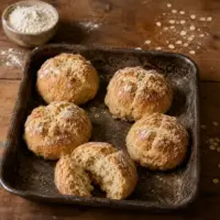 Golden homemade soda bread rolls with oats and a soft, rustic crumb.